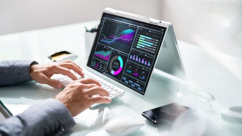 An operator analyzes automation observability telemetry, job execution trends, and SLA performance metrics on an enterprise analytics dashboard.