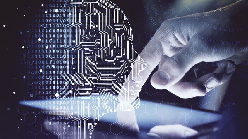 Human hand interacting with a digital tablet displaying a glowing circuit-board AI head profile and binary data streams, representing Automic Automation as an intelligent control plane for enterprise AI and data pipelines.